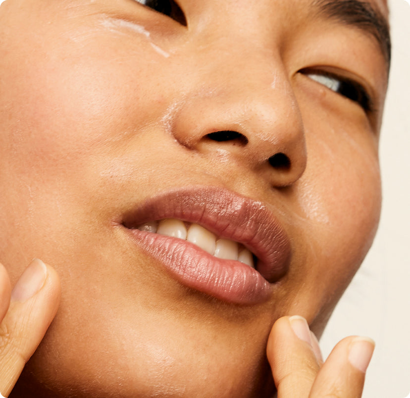 Woman applying Seven 8ths rebalancing face moisturizer with honey and royal jelly